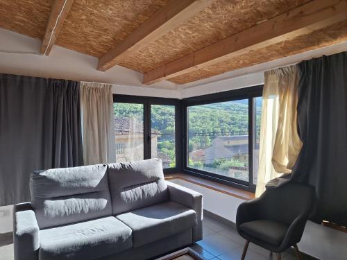 a living room with a couch and a chair at Dúplex Sant Martí in Ager