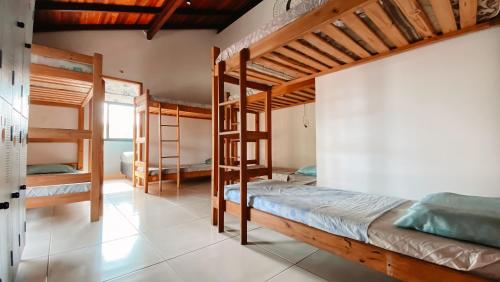 a bedroom with three bunk beds in a room at Sagui Hostel in Florianópolis
