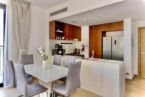 a kitchen and dining room with a white table and chairs at Ocean Majestic Full Sea View at Le Pont in Dubai