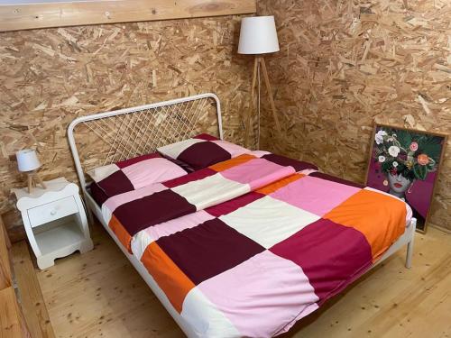 a bed with a colorful comforter in a bedroom at Studio Cosy Mezzanine in Talence