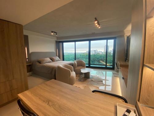 a bedroom with a bed and a table with chairs at Mansión Botánico Luxury Buenos Aires in Buenos Aires