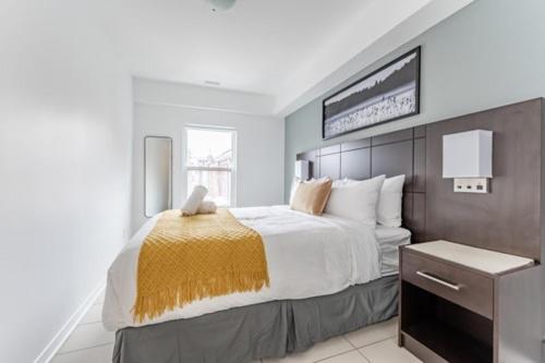 a bedroom with a large bed and a sign on the wall at 300 Front Suites in Toronto