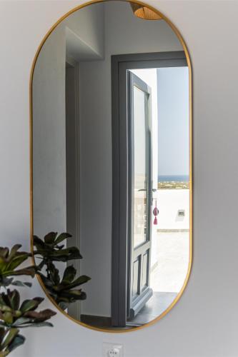 a mirror in a bathroom with a window at Villa Lagkadia in Glinádhon