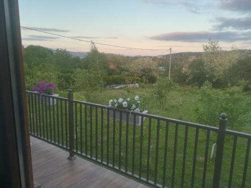 a balcony with a fence and a view of a field at Banjska brvnara in Vrnjačka Banja