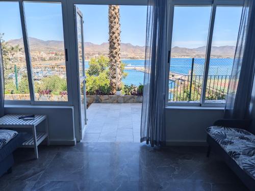 Habitación con ventanas grandes y vistas al océano. en El Faro seacave en El Puerto de Mazarrón