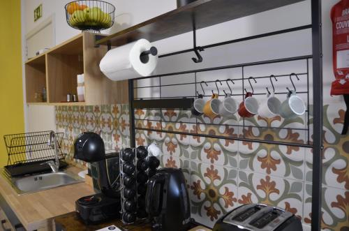a kitchen with pots and pans hanging on a wall at Your Modern Comfort Home in Malta in Mosta