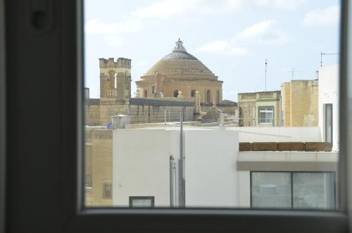 a view of a building from a window at Your Modern Comfort Home in Malta in Mosta