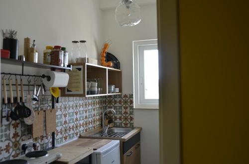 a kitchen with a sink and a window at Your Modern Comfort Home in Malta in Mosta