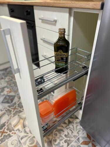 a bottle of alcohol sitting on a shelf in a refrigerator at Timco apartment with big terrace, partial lake view and air-conditioner in Torno