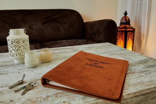a table with a book on top of a table at The Back Street Nest in Lisbon