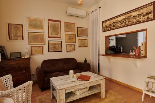 a living room with a couch and a table at The Back Street Nest in Lisbon