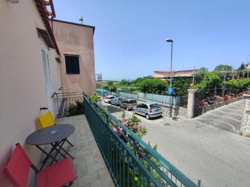 a balcony with a table and chairs and a street at Camelia Vico Equense in Vico Equense