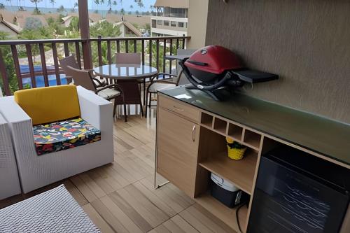 a kitchen with a grill on a counter on a balcony at Malawi Beach Resort - Flat SKY in Porto De Galinhas