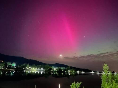 a light display in the sky over a lake at night at Bielawa Góry Sowie in Bielawa