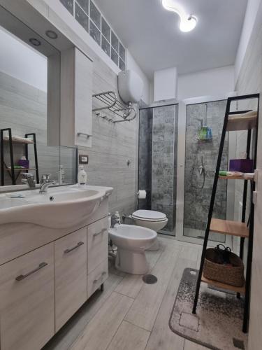 a bathroom with a sink and a toilet and a shower at Home Santa Chiara Marigliano in Marigliano
