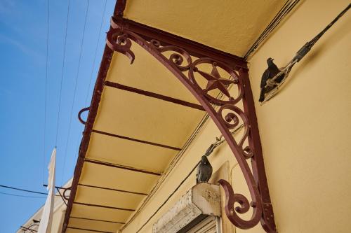 a building with a bird sitting on the side of it at The Back Street Nest in Lisbon