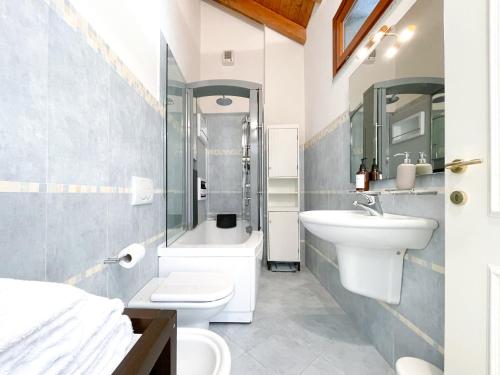 a bathroom with a sink and a toilet and a shower at Villa Luminosa Laglio - Private Parking, Garden in Laglio