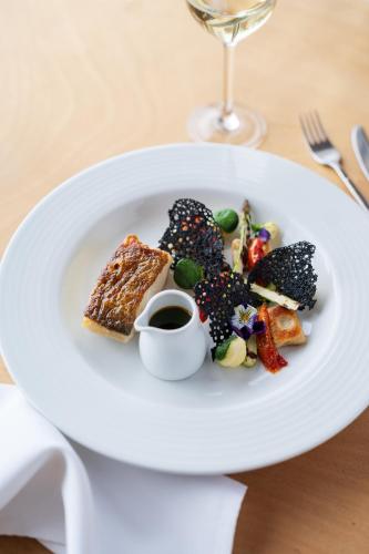 a white plate with food on a table at Watersmeet Hotel in Woolacombe