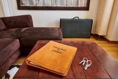 a living room with a coffee table with a happy first birthday book at The Sunset Hideout in Lisbon