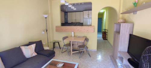 a living room with a couch and a table at Apartamento Aquila Parque in Fuengirola