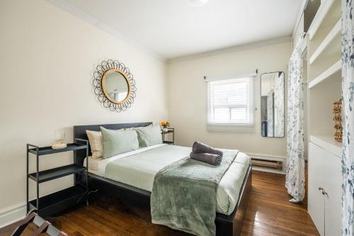 a bedroom with a bed and a mirror on the wall at Modern Condo 1BR - Near Trinity Bellwoods Park in Toronto