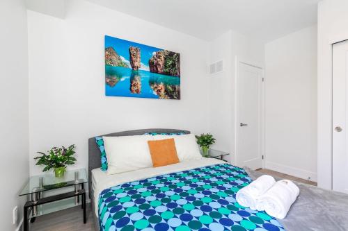 a bedroom with a bed with blue and white at Modern 3BR Condo - Walking Distance to High Park in Toronto