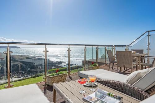 a balcony with a table and a view of the ocean at Watersmeet Hotel in Woolacombe