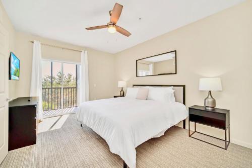 a bedroom with a white bed and a window at 3BR Condo - Near Disney Balcony Pool Hot tub in Orlando