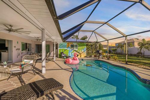 a swimming pool with a pink flamingo in a house at Entertainers Paradise with HTD Pool & Putting Green in Cape Coral
