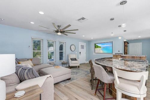 a living room with a couch and a table at Entertainers Paradise with HTD Pool & Putting Green in Cape Coral