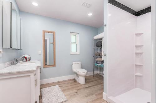 a bathroom with a toilet and a walk in shower at Entertainers Paradise with HTD Pool & Putting Green in Cape Coral