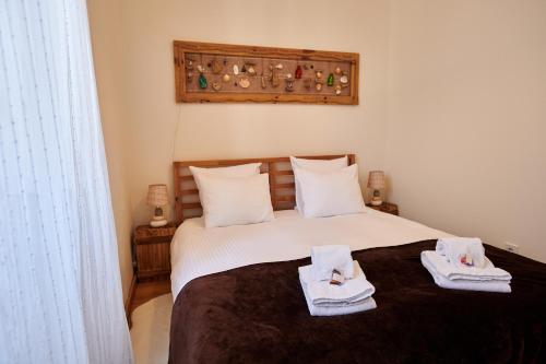 a bedroom with a bed with towels on it at The Hilltop Nest in Lisbon