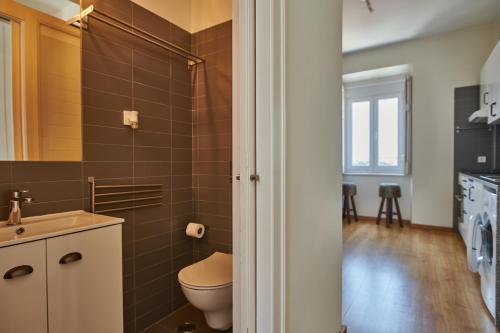 a bathroom with a toilet and a sink at The Hilltop Nest in Lisbon