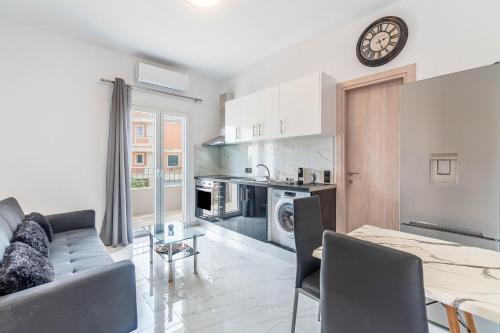 a kitchen and living room with a couch and a table at Rozario in Alepou