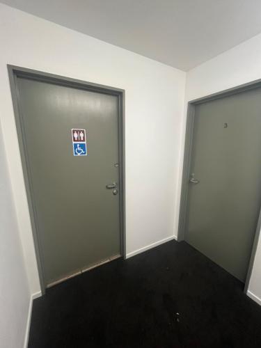 two doors in an office with a sign on them at Kaikoura Seaside lodge in Kaikoura
