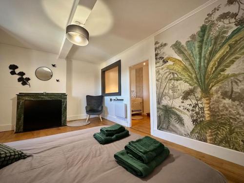 a bedroom with a bed with two green pillows on it at Le gîte du besson Cassagne in Cassagne