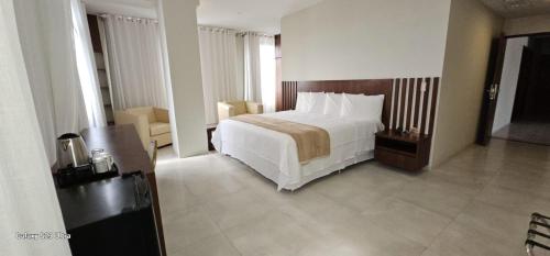 a bedroom with a large white bed in a room at Hotel Maywa in Santa Cruz de la Sierra