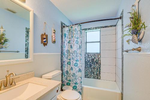 a bathroom with a shower and a toilet and a sink at Waterfront Hernando Beach Home with Dock and Hot Tub! in Hernando Beach