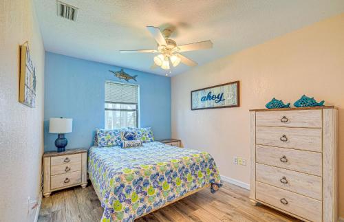 a bedroom with a bed and a ceiling fan at Waterfront Hernando Beach Home with Dock and Hot Tub! in Hernando Beach