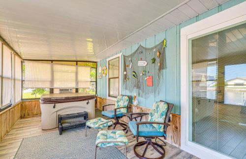 a room with two chairs and a table and a fireplace at Waterfront Hernando Beach Home with Dock and Hot Tub! in Hernando Beach