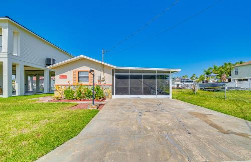 a house with a garage in front of it at Waterfront Hernando Beach Home with Dock and Hot Tub! in Hernando Beach