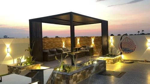 a rooftop patio with a gazebo at dusk at استراحه فندقيه فخمه نطاق المدينه بخصم ترويجي in Billah
