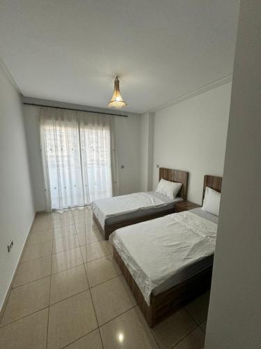 a bedroom with two beds and a window at welcome to ur appr in Agadir