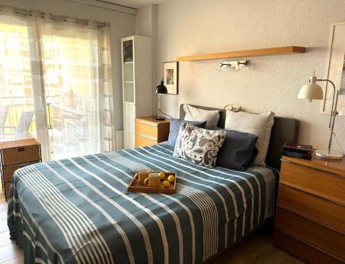 a bedroom with a bed with a tray of oranges on it at Cozy apartment near Los Boliches Beach in Fuengirola