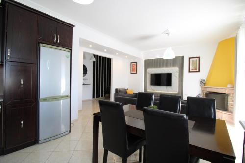 a kitchen and living room with a table and chairs at Omnia Apartments in Ksamil