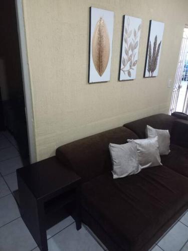 ZapotlanejoにあるCasa Susiの茶色のソファと写真が飾られたリビングルーム