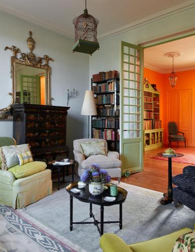 a living room with two chairs and a table at Domaine Maze Churchill in Burie