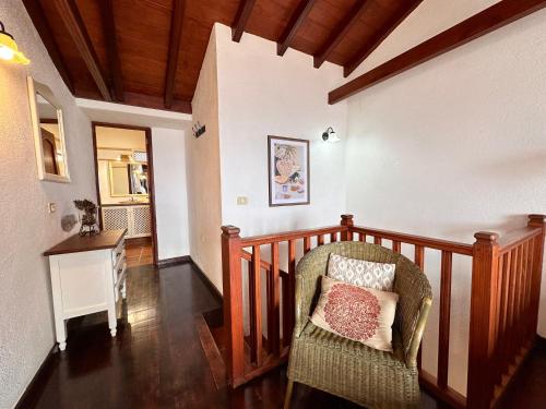 a room with a chair with a pillow on it at Villa Delfines - Adults Only in Agulo