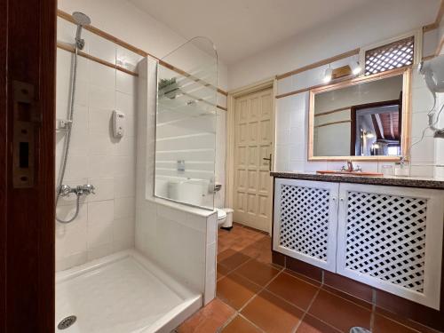 a bathroom with a shower and a sink and a toilet at Villa Delfines in Agulo