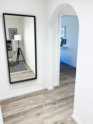 a mirror on a wall in a living room at Penthouse - Zentral und Genial in Passau